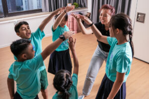Children in a group setting with guidance from an educator.