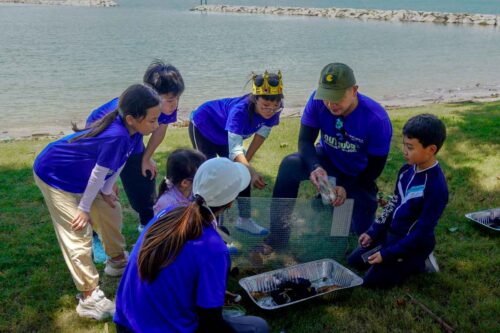southern voyagers holiday camp children holding team flag at beach